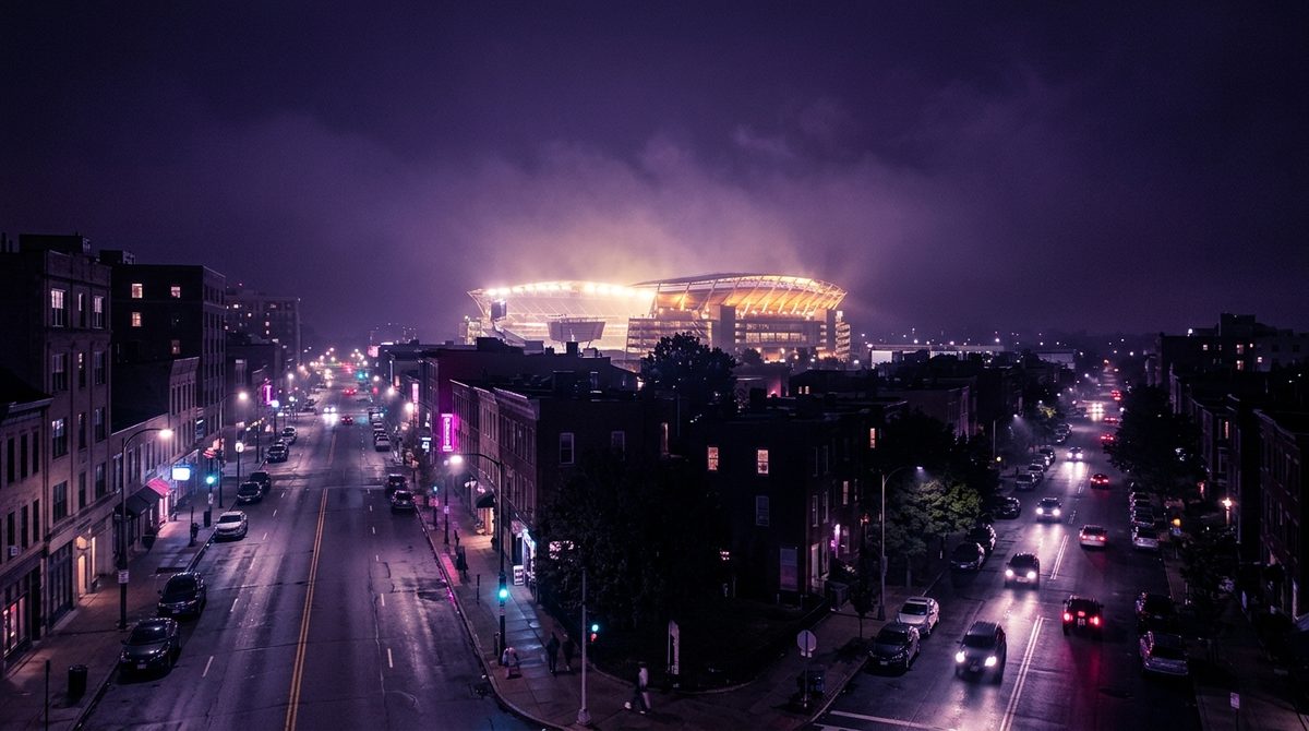 Dua jalan berbeda di malam berkabut menuju stadion yang sama dengan lampu menyala